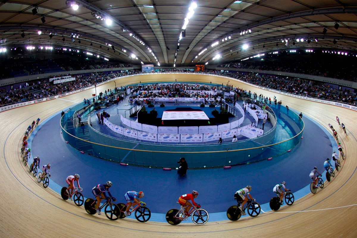 A wide-angled photograph showing riders cycling round one end of the track at Manchester’s National Cycling Centre during the British Cycling National Track Championships 2017