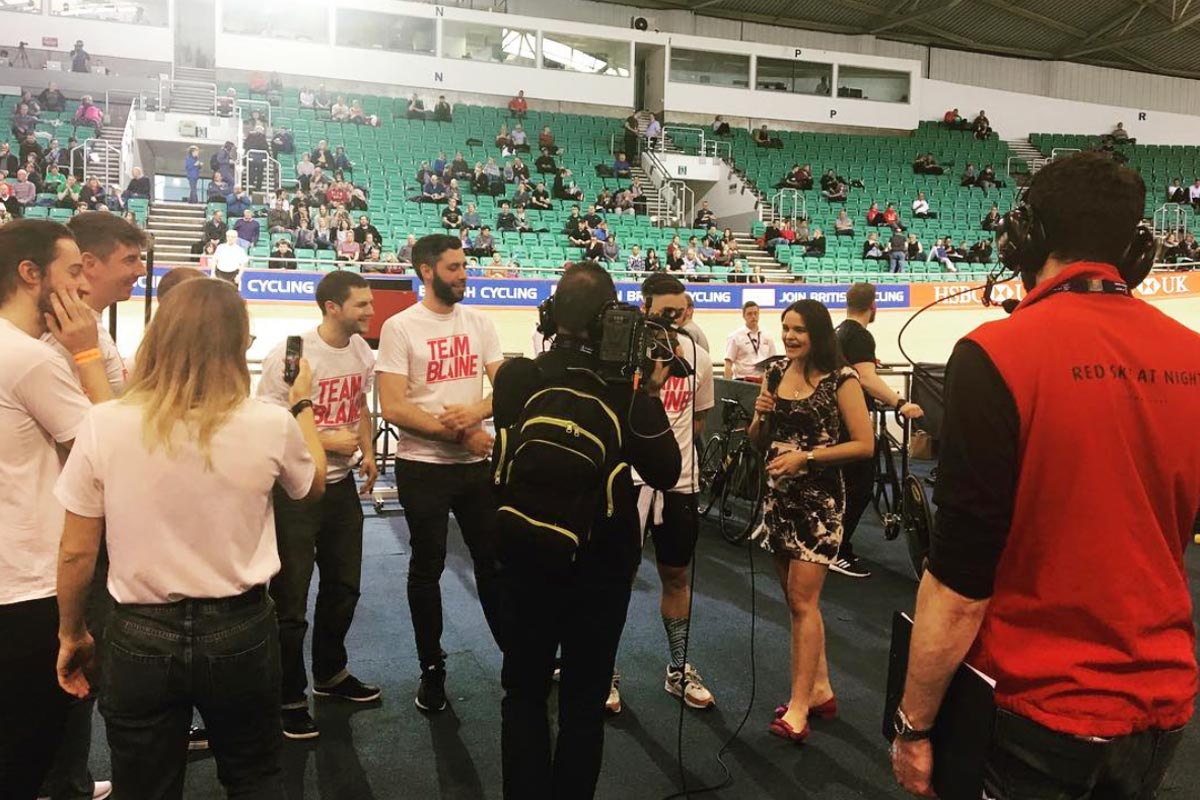 A photo of long-time RSAN collaborator Laura Winter conducting an interview at the 2018 British Cycling National Track Championships