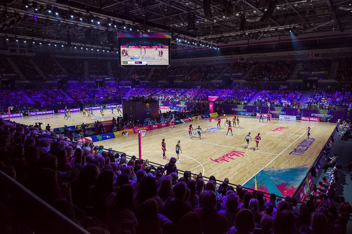 A photo of the M&S Bank Arena in Liverpool, with large crowds watching two matches take place at the Vitality Netball World Cup 2019